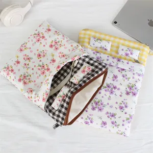 Close-up detail of cute bed style quilted laptop sleeve with floral pattern and zipper.