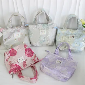 Vintage embossed jacquard tote bag, stylish lunch handbag with durable handle and smooth zipper.
