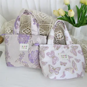 Detail view of vintage jacquard lunch tote bag, featuring elegant floral and butterfly patterns.