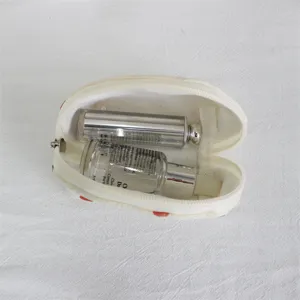 Cute shell cosmetic pouch detail showcasing interior capacity with lipstick and skincare bottles.