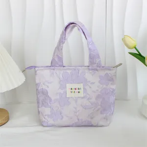 Detail view of the retro embossed jacquard lunch bag featuring elegant floral pattern.