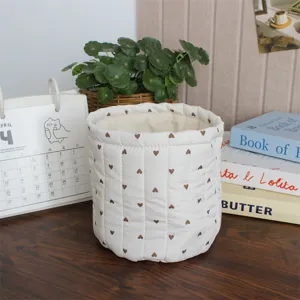 Quilted fabric storage basket with cute heart pattern, ideal for desktop organization.