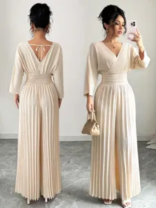 Elegant beige pleated wide-leg jumpsuit featuring a chic V-neck, cinched waist, and stylish back tie.