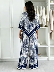 Detail view of the blue and white printed two-piece outfit featuring elegant jungle patterns.