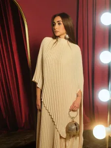 Detailed view of the elegant beige pleated asymmetric dress featuring a chic high neckline.