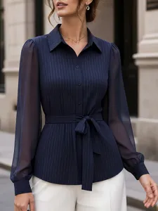 Detailed view of women's pinstripe mesh patchwork belted long sleeve blouse in navy blue.