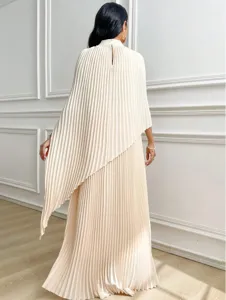 Detail view of the elegant pleated cape top and long skirt set in beige, showing the fluid drape.