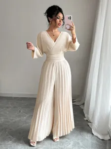 Elegant beige V-neck pleated wide-leg jumpsuit for women, stylish commute chic outfit.