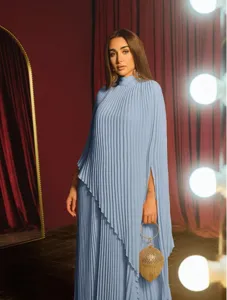 Light blue pleated two-piece dress set with irregular hem, loose cape sleeves and matching gold bag.