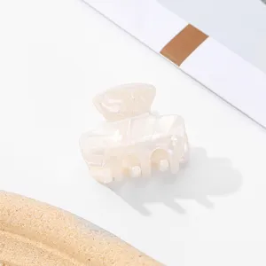 Mini hair claw clip for women, cute small hair accessory for bangs and half updo.
