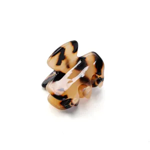 Mini tortoiseshell hair claw clip for women, cute small hair accessory for styling side fringe.