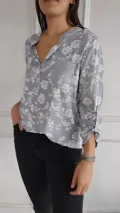 Detailed view of a casual long-sleeve floral print blouse featuring a sequin pocket.