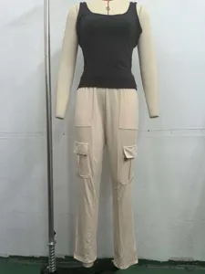 Women's two-piece sportswear set featuring a black tank top and beige cargo pants.