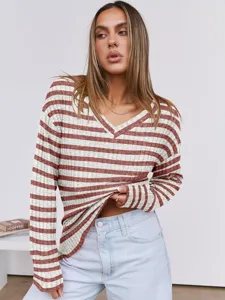 Close-up detail of the cozy striped v-neck knit sweater with soft texture and stylish design.
