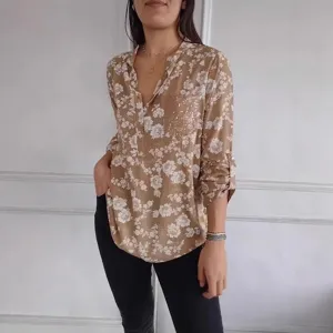 Women's casual long sleeve floral print blouse with sequin pocket and V-neck design.
