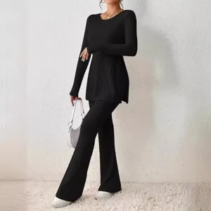Women solid color long sleeve ribbed knit top and flared pants set, full body view shot.