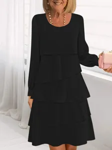 Dettaglio abito nero a balze maniche lunghe, scollo rotondo elegante moda donna autunno.
