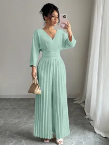 Mint green V-neck pleated wide leg jumpsuit detail showcasing elegant waist design and sleeves.
