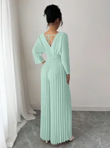 Back view detail of the mint green pleated jumpsuit featuring V-neck and tie back design.