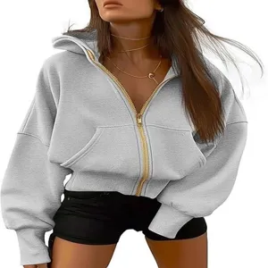 Detailed view of the gray zip-up hoodie featuring a bold gold zipper and casual design.