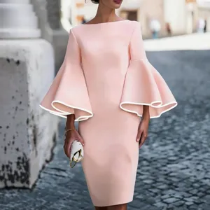 Elegant pink dress featuring dramatic bell sleeves with white trim and a slim-fit bodycon silhouette.