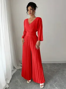 Detailed view of elegant red V-neck pleated wide-leg jumpsuit with waist cinching.