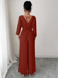 Detailed view of women's elegant solid color V-neck pleated wide-leg jumpsuit with waist cinched.