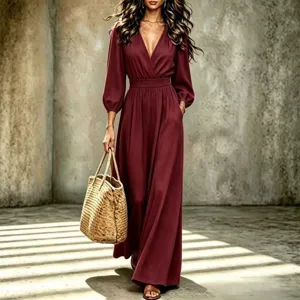 Detailed view of the elegant burgundy long-sleeve V-neck maxi dress with chic woven straw bag.