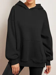 Detailed view of the solid color oversized hoodie featuring a cozy hood and front pocket.