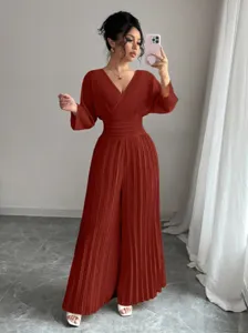 Detailed view of the elegant V-neck pleated wide-leg jumpsuit, showcasing the fitted waist.