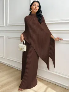 Detail view of elegant brown pleated loose asymmetrical two-piece outfit setting.