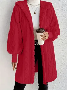 Detailed view of women's red fuzzy hooded long sleeve coat paired with white turtleneck.