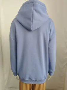 Back view of women solid loose hooded long sleeve sweatshirt in casual autumn style.