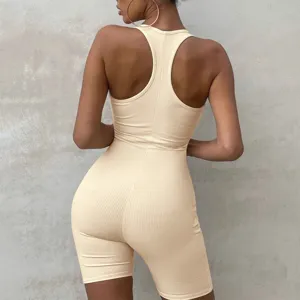 Back detail of solid color ribbed knit yoga jumpsuit, high waist tight fit activewear.