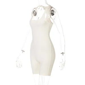 Detailed view of white ribbed knit romper, close-up on breathable stretch fabric texture.