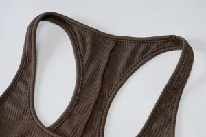 Brown ribbed racerback detail view of women's fitness activewear top close-up shot.