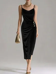 Detail shot of the glittering gold velvet slip dress, featuring elegant cowl neckline and side buttons.