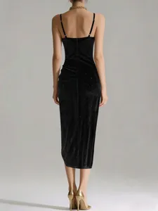 Detailed back view of a black sparkly velvet slip dress, showing slim straps and bodycon fit.