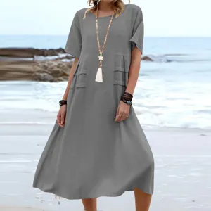 Casual summer short sleeve midi dress detail shot, featuring solid grey tone and beach scene.
