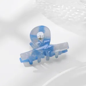Molla per capelli in acetato blu e bianco con design a fiocco per acconciature eleganti.