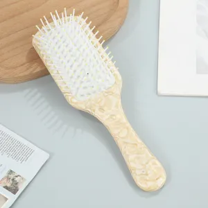 Stylish aesthetic air cushion hair brush with chic acetate pattern handle for daily scalp massage.
