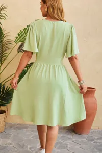 Elegant light green V-neck waist-cinching flared sleeve midi dress for women's daily wear.