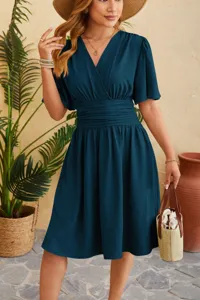 Detailed view of the elegant V-neck cinched waist flared sleeve dress in deep teal.