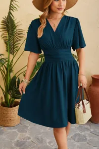 Detail shot of a stylish V-neck puff sleeve midi dress in dark green, ideal for summer.
