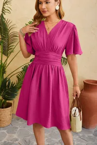 Detail view of the elegant V-neck ruched waist flared sleeve dress in bright pink color.