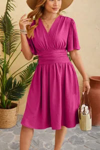 Detail view of the elegant V-neck cinched waist flared sleeve women dress for summer season.