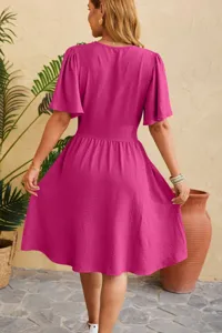 Back view detail of magenta V-neck mini dress with trumpet sleeves and waist cinching design.