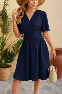 Elegant dark blue V-neck flared sleeve midi dress with cinched waist for summer style.