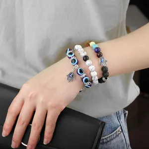Handmade beaded bracelet set featuring evil eye charms and hamsa hand pendants for women.