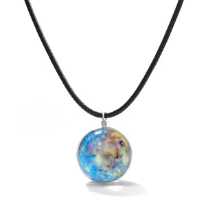 Detailed close-up of the glowing galaxy glass ball pendant necklace with a black cord.